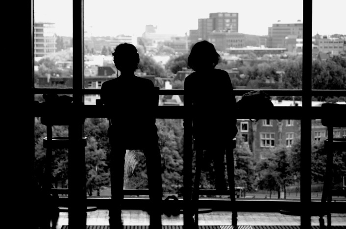 A Couple sitting in Amsterdam Library Cafe enjoying a Panoramic View of the city