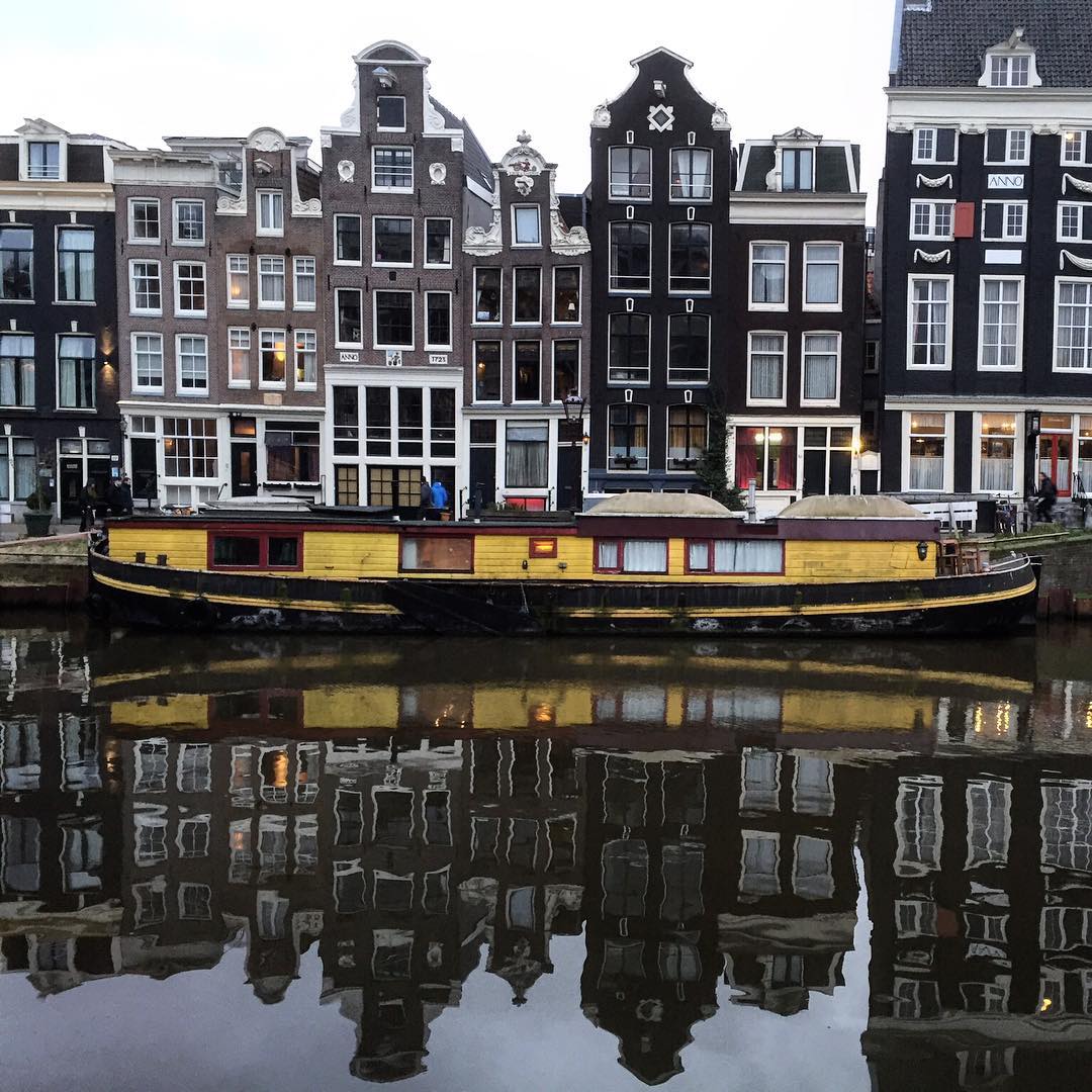 amsterdam canal houses and houseboat singel