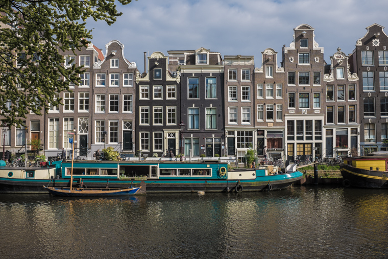 Canal Houses and blue houseboat on Amsterdam Singel